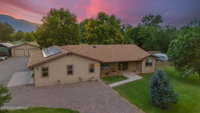 a view of a house with a yard and garage
