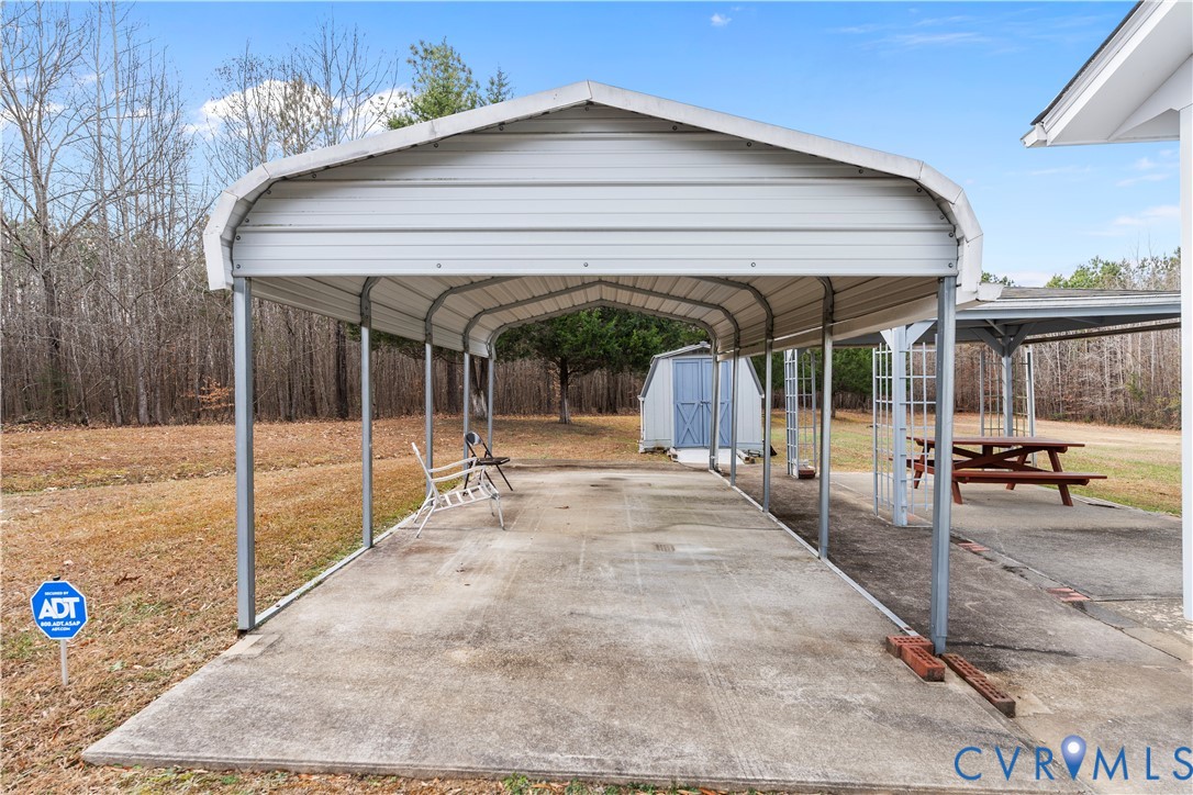 927 East Courthouse Road Blackstone, VA 23824 - Photo 17 of 23 View of parking with a shed and a carport