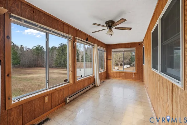 a view of a porch with a table and chairs