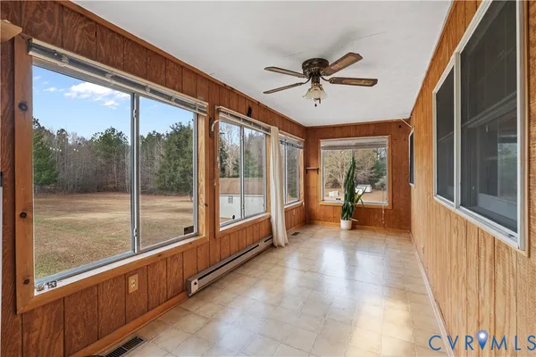 a view of a porch with a table and chairs