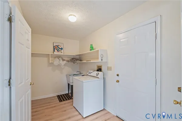 a utility room with cabinets washer and dryer