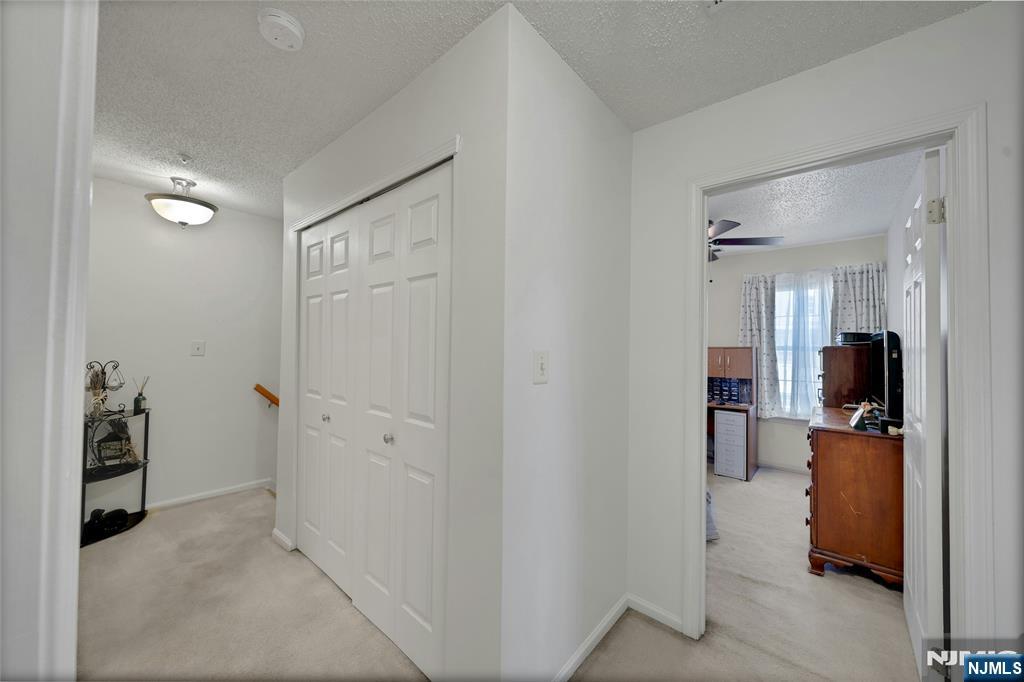 72 Marrow Street, Unit 3101 Newark, NJ 07103 - Photo 12 of 20 a view of a hallway with workspace and a livingroom