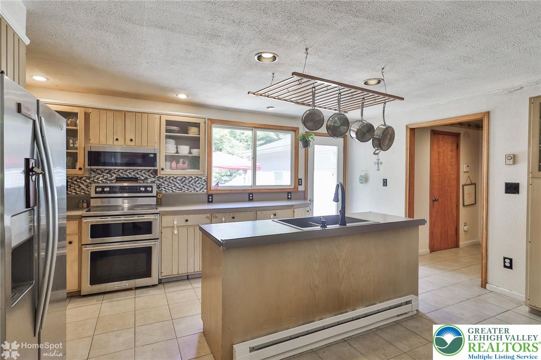 60 Sassafras Road Lehighton, PA 18235 - Photo 13 of 36 Culinary delights await in this well-appointed kitchen, featuring a practical island and direct outdoor access.