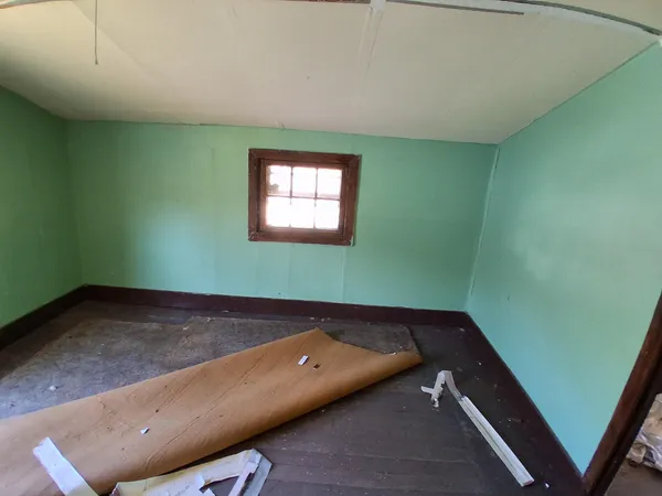 a living room with furniture a window and wooden floor