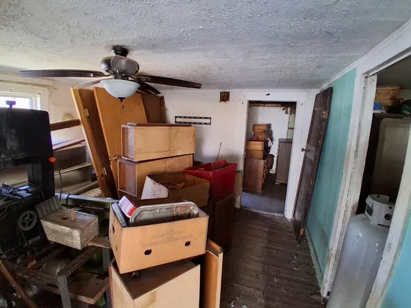 a view of a workspace with furniture and a flat screen tv