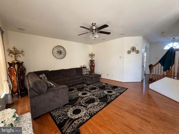 a living room with a couch and a table with wooden floor
