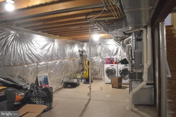 a view of a room with wooden floor and ceiling fan