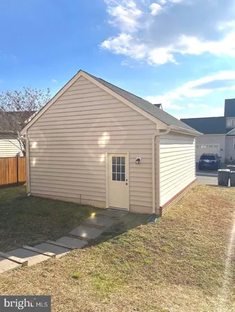 a front view of building with yard and car parked