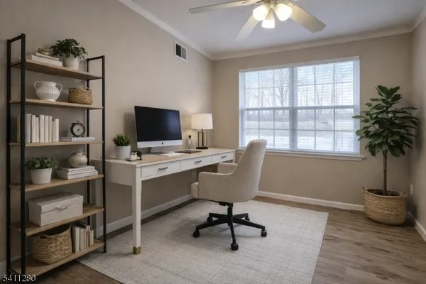 a view of a workspace with furniture and a window