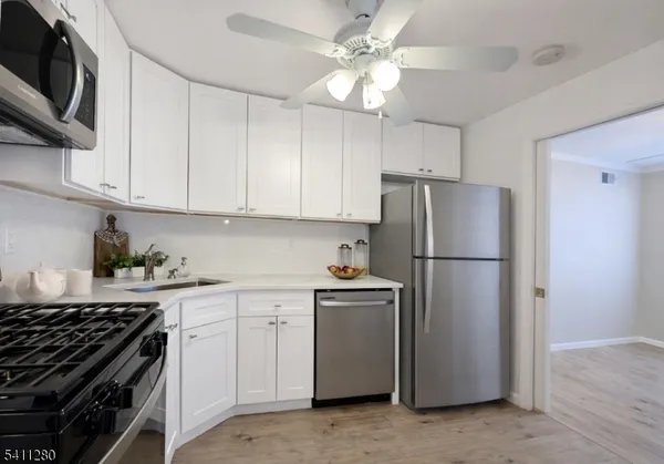 a kitchen with a stove a refrigerator and a sink