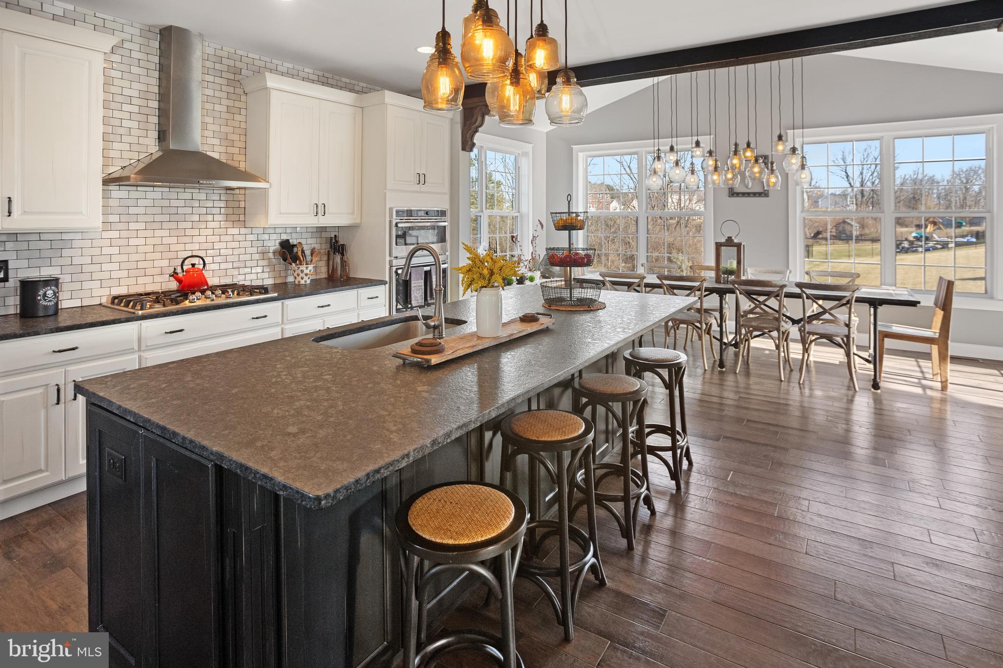 33 Docwill Drive Barto, PA 19504 - Photo 14 of 54 a kitchen with stainless steel appliances granite countertop a table chairs stove and wooden floor