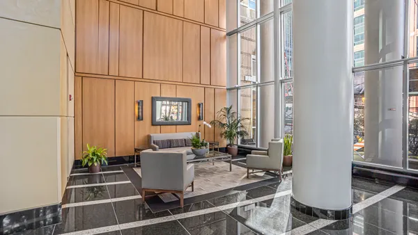 a room with furniture a window and potted plant