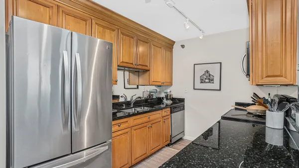 a kitchen with stainless steel appliances a refrigerator and a stove top oven