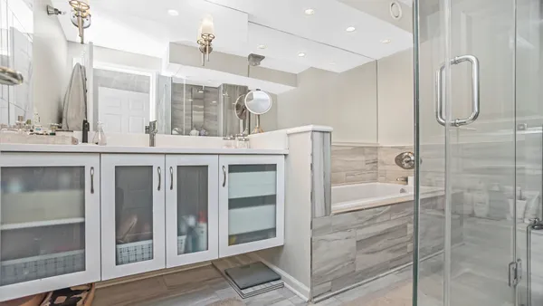 a bathroom with a double vanity sink a mirror and a shower