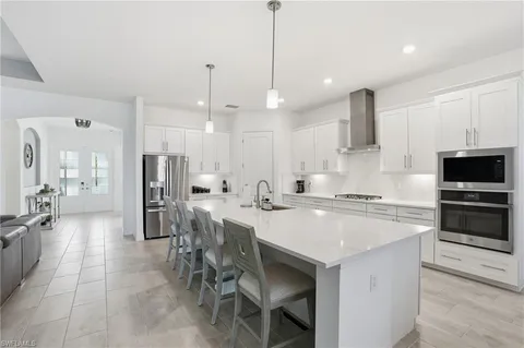 a large kitchen with a table and chairs