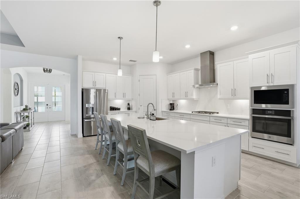 13686 Blue Bay Circle Fort Myers, FL 33913 - Photo 15 of 50 a large kitchen with a table and chairs