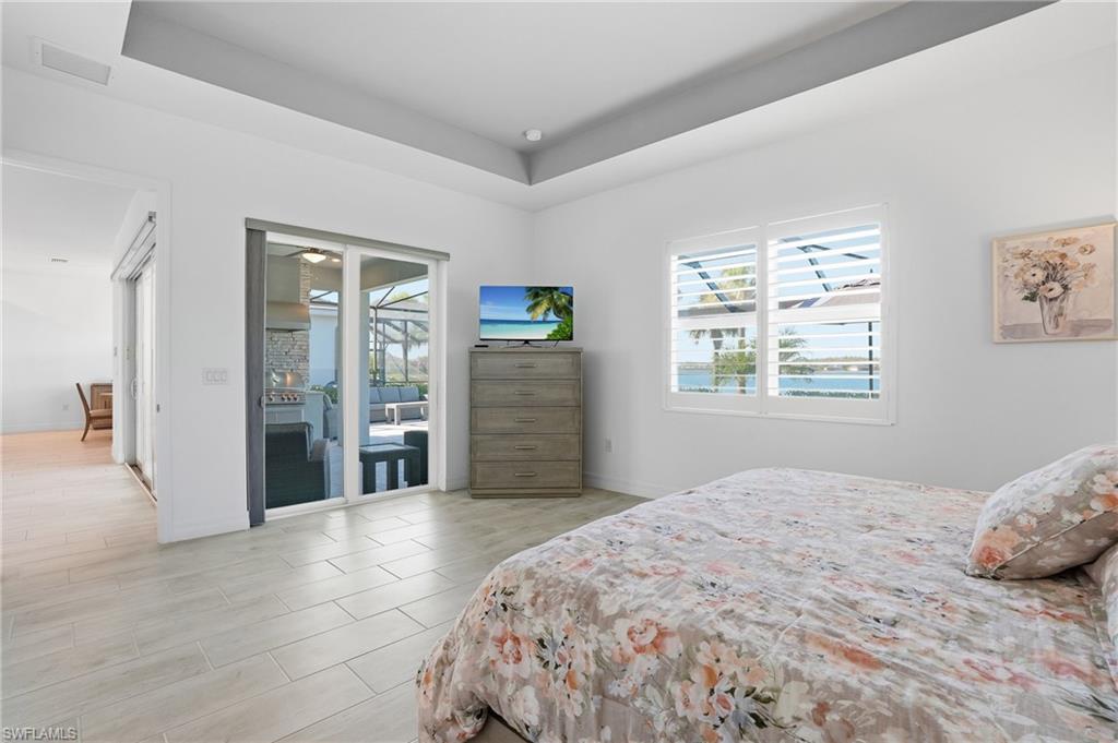 13686 Blue Bay Circle Fort Myers, FL 33913 - Photo 20 of 50 a bedroom with a large bed and a window