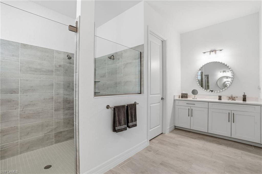 13686 Blue Bay Circle Fort Myers, FL 33913 - Photo 22 of 50 a bathroom with a double vanity sink mirror and shower