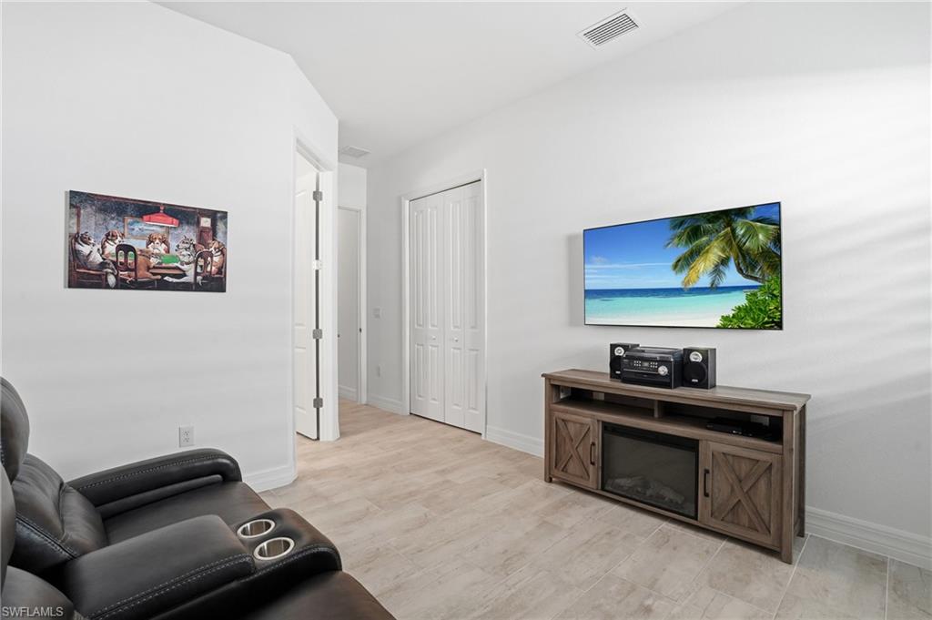 13686 Blue Bay Circle Fort Myers, FL 33913 - Photo 28 of 50 a living room with furniture and a flat screen tv