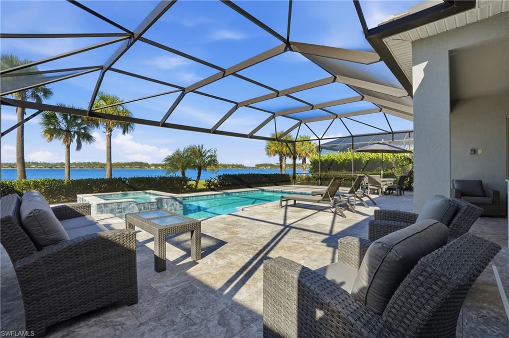 13686 Blue Bay Circle Fort Myers, FL 33913 - Photo 35 of 50 a view of a patio with a table and chairs under an umbrella