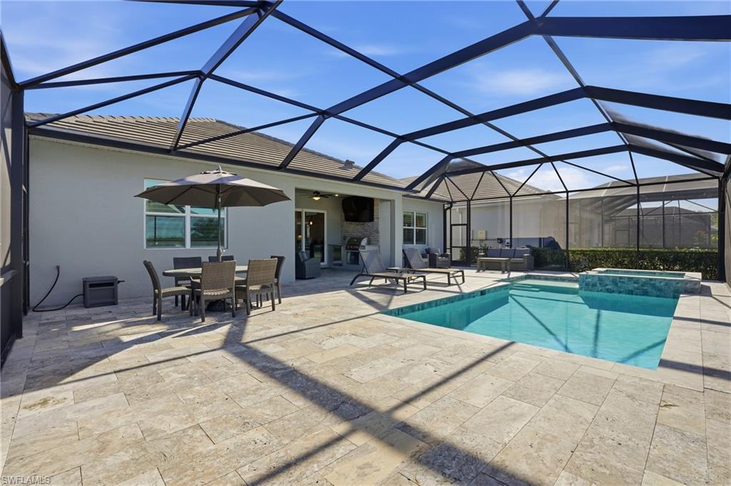 13686 Blue Bay Circle Fort Myers, FL 33913 - Photo 39 of 50 a view of a swimming pool with chairs and tables in the patio