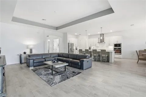 a living room with furniture and kitchen view