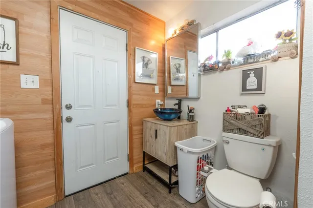 a bathroom with a toilet a sink and a window