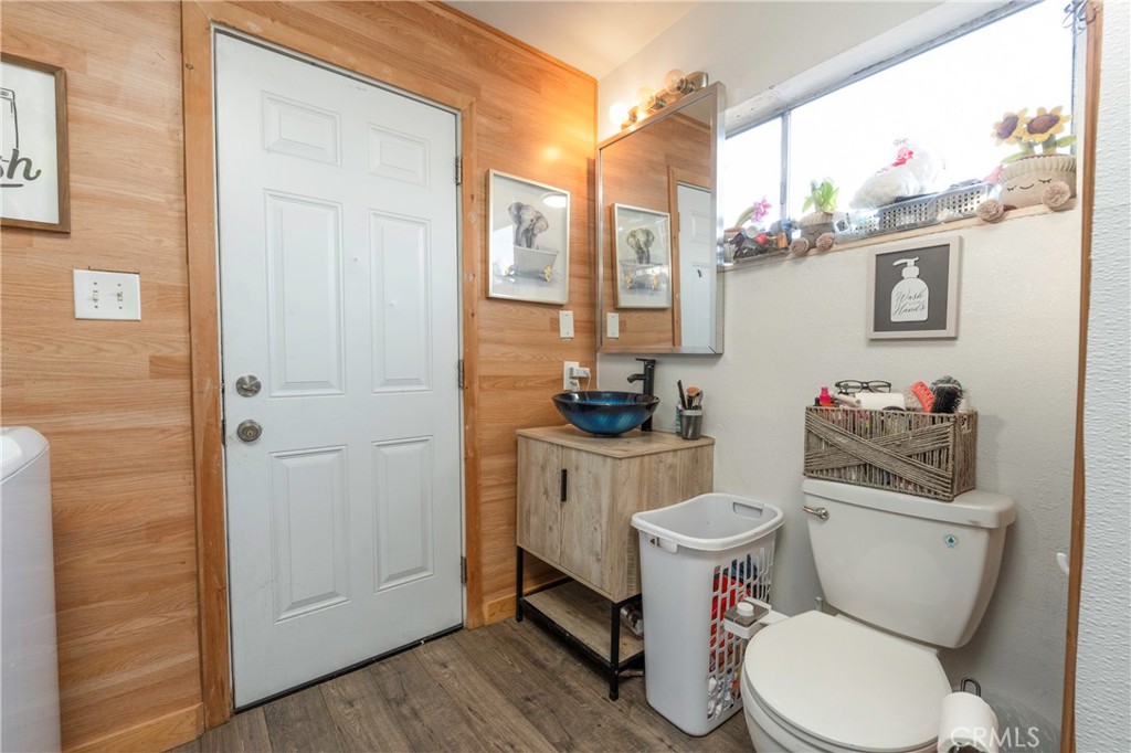 11661 Valverda Avenue Riverside, CA 92505 - Photo 23 of 39 a bathroom with a toilet a sink and a window