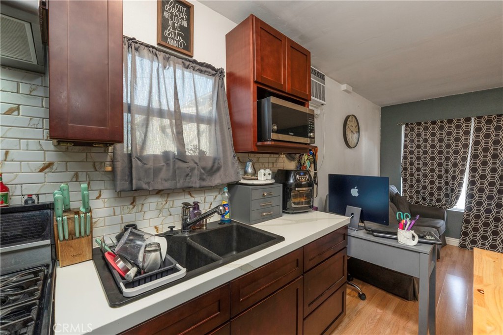 11661 Valverda Avenue Riverside, CA 92505 - Photo 29 of 39 a kitchen with a sink cabinets and a stove top oven