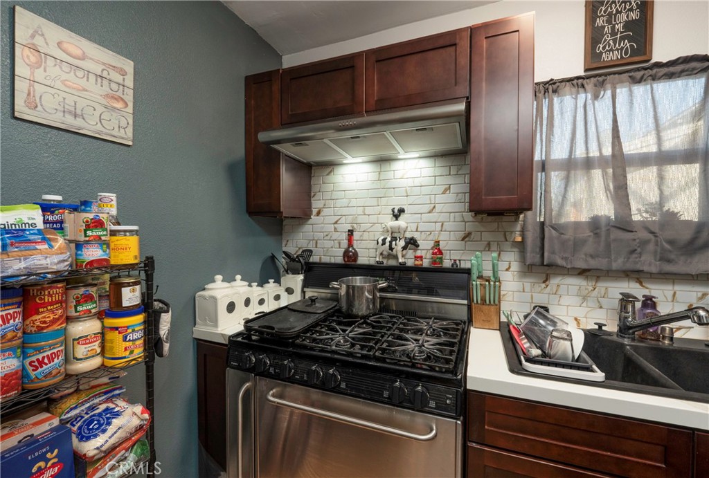 11661 Valverda Avenue Riverside, CA 92505 - Photo 30 of 39 a kitchen with stainless steel appliances granite countertop a stove and a sink
