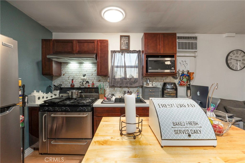 11661 Valverda Avenue Riverside, CA 92505 - Photo 31 of 39 a kitchen with a stove and a refrigerator