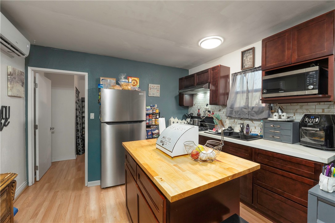11661 Valverda Avenue Riverside, CA 92505 - Photo 32 of 39 a kitchen with a refrigerator microwave and sink