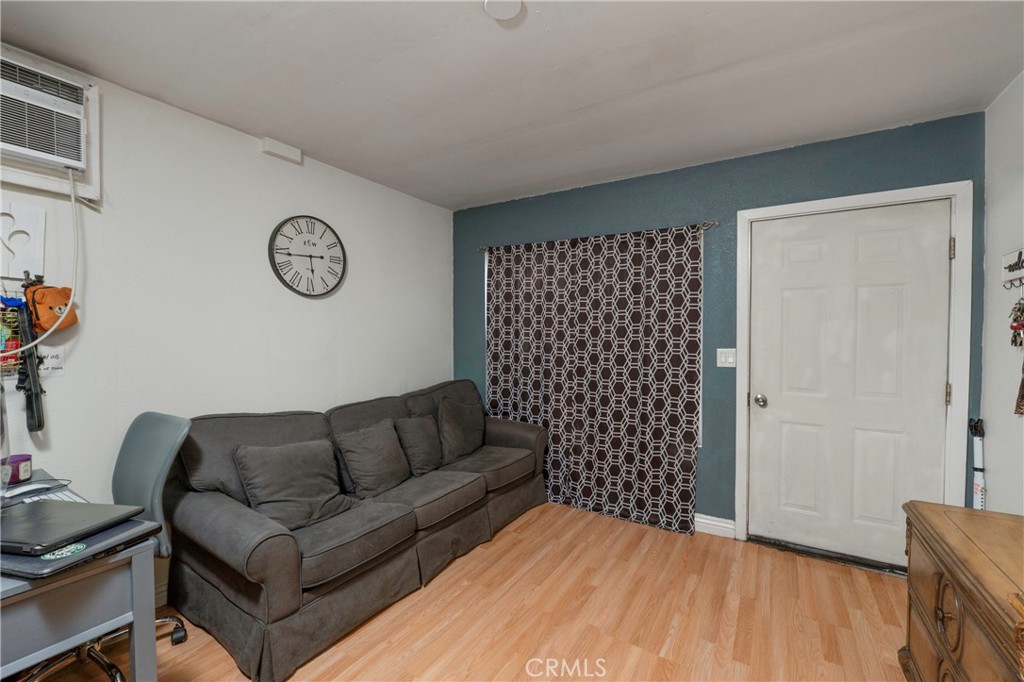 11661 Valverda Avenue Riverside, CA 92505 - Photo 33 of 39 a living room with a couch and a table with wooden floor