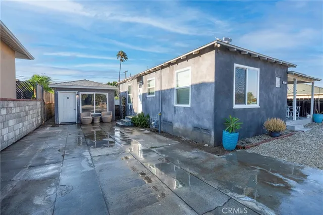 a backyard of a house with outdoor seating