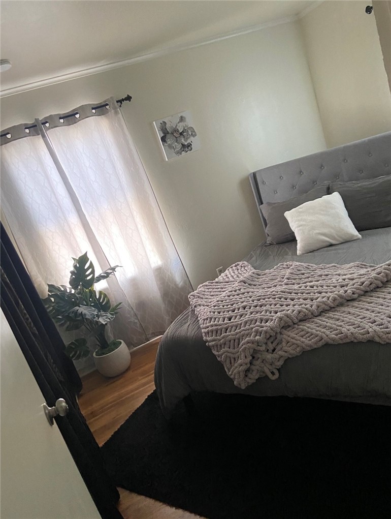 11661 Valverda Avenue Riverside, CA 92505 - Photo 6 of 39 a bedroom with a bed painting on the wall and a potted plant