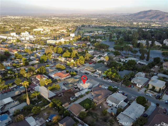 an aerial view of residential houses with city view