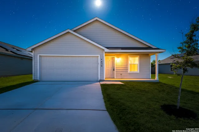 a front view of house with yard and green space