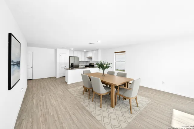 a view of a kitchen with wooden floor and a sink