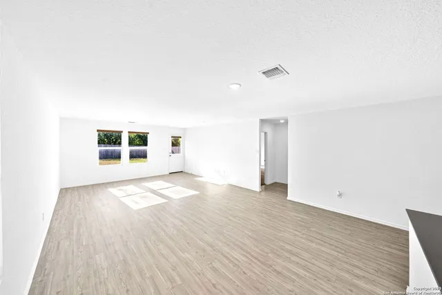 a bedroom with a bed and a potted plant