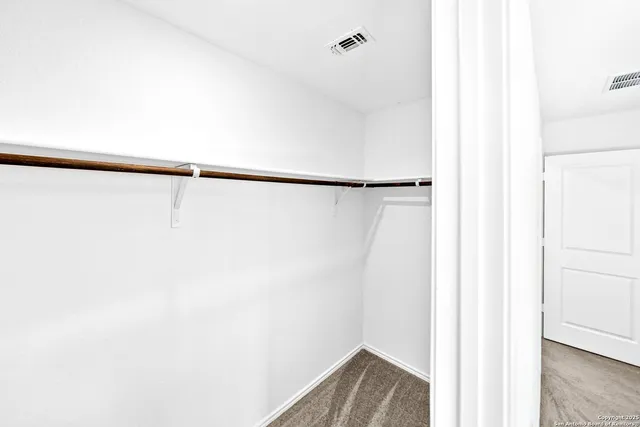 a bedroom with a bed and a potted plant