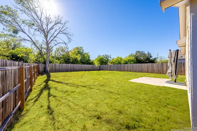a view of a backyard with a garden and yard