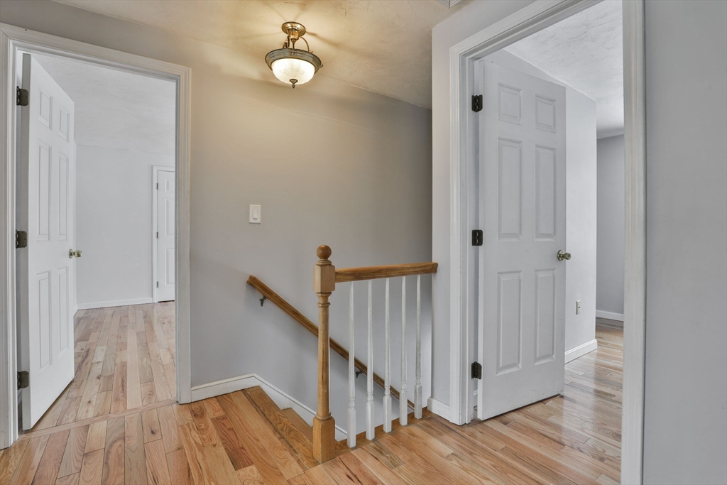 1 Deer Path Lane Mansfield, MA 02048 - Photo 18 of 31 a view of a hallway with wooden floor and staircase