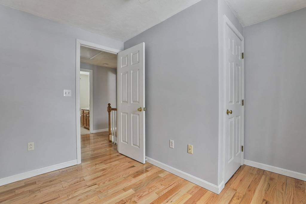 1 Deer Path Lane Mansfield, MA 02048 - Photo 25 of 31 a view of a hallway with wooden floor and closet area