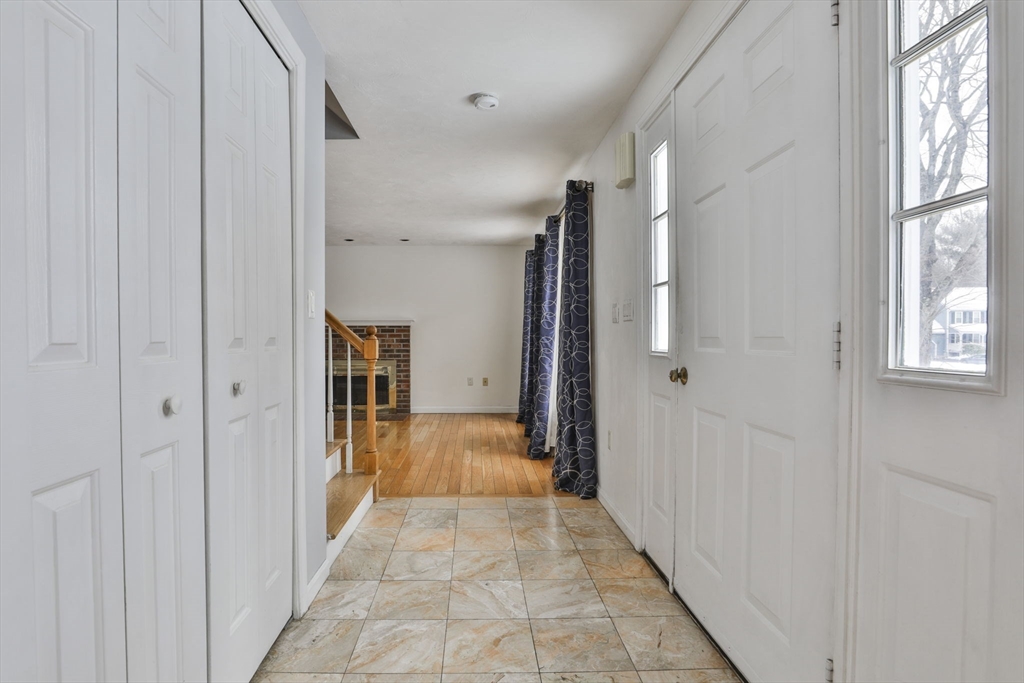 1 Deer Path Lane Mansfield, MA 02048 - Photo 3 of 31 a view of a hallway with wooden floor and windows