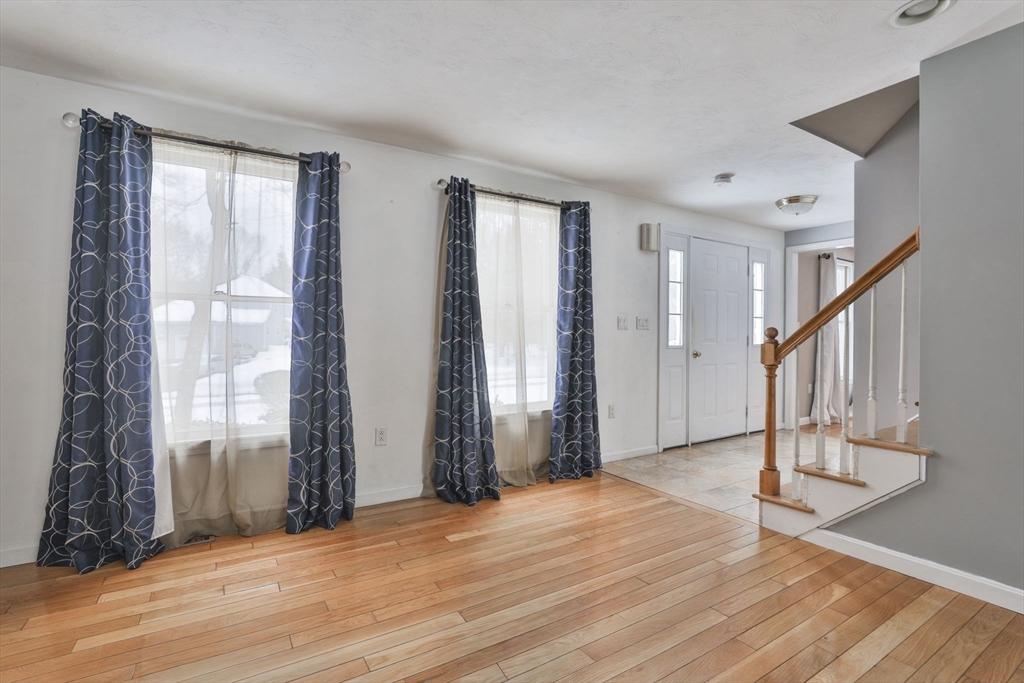 1 Deer Path Lane Mansfield, MA 02048 - Photo 4 of 31 a view of an empty room with wooden floor and stairs