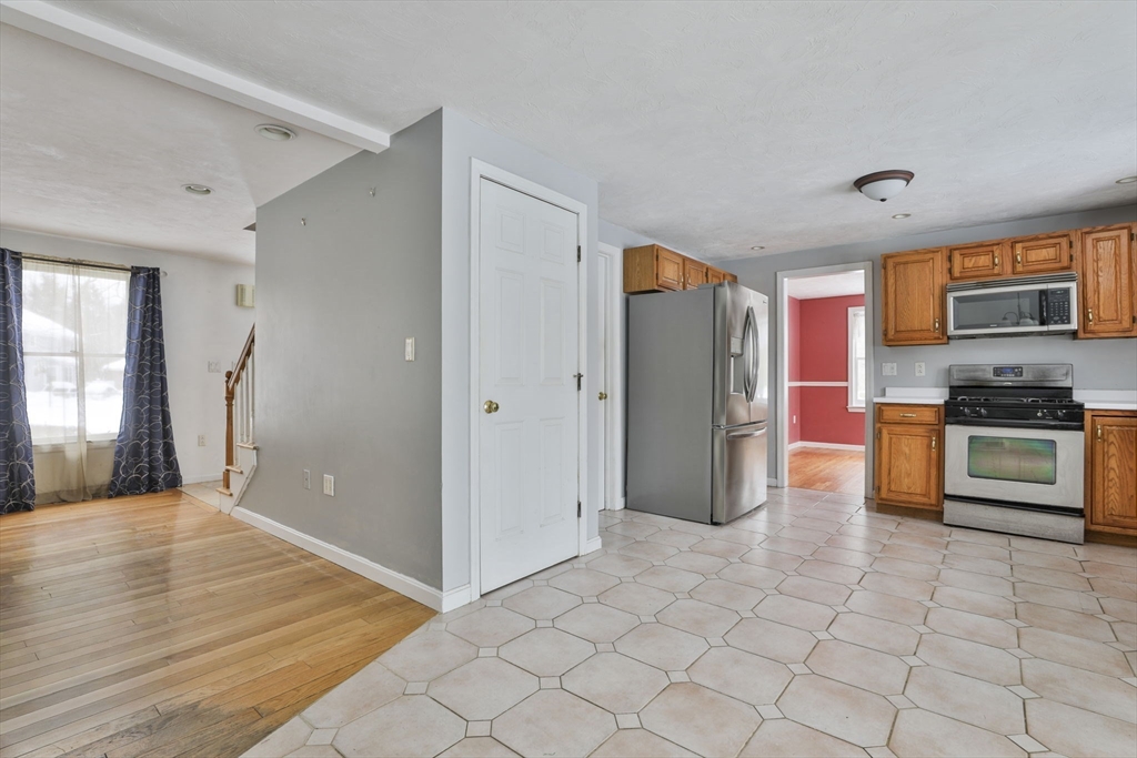 1 Deer Path Lane Mansfield, MA 02048 - Photo 7 of 31 a kitchen with stainless steel appliances a refrigerator and a stove top oven