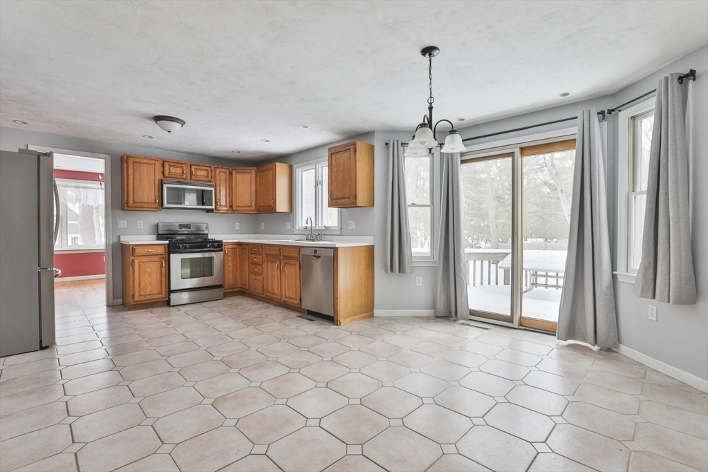 1 Deer Path Lane Mansfield, MA 02048 - Photo 8 of 31 a kitchen with stainless steel appliances granite countertop a stove top oven a sink a counter top space cabinets and a window