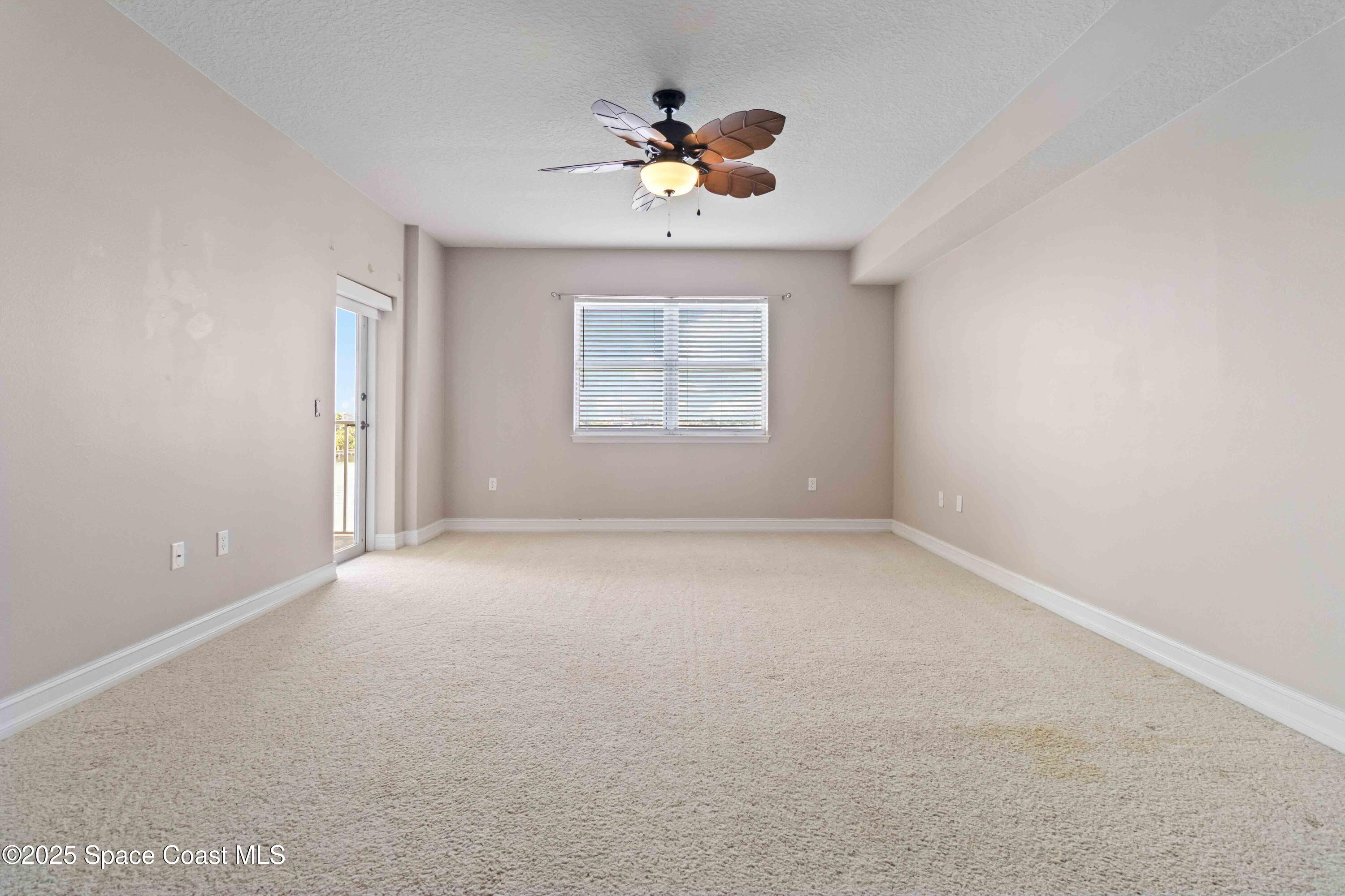134 Starboard Lane, Unit 404 Merritt Island, FL 32953 - Photo 12 of 30 en view of an empty room with a window