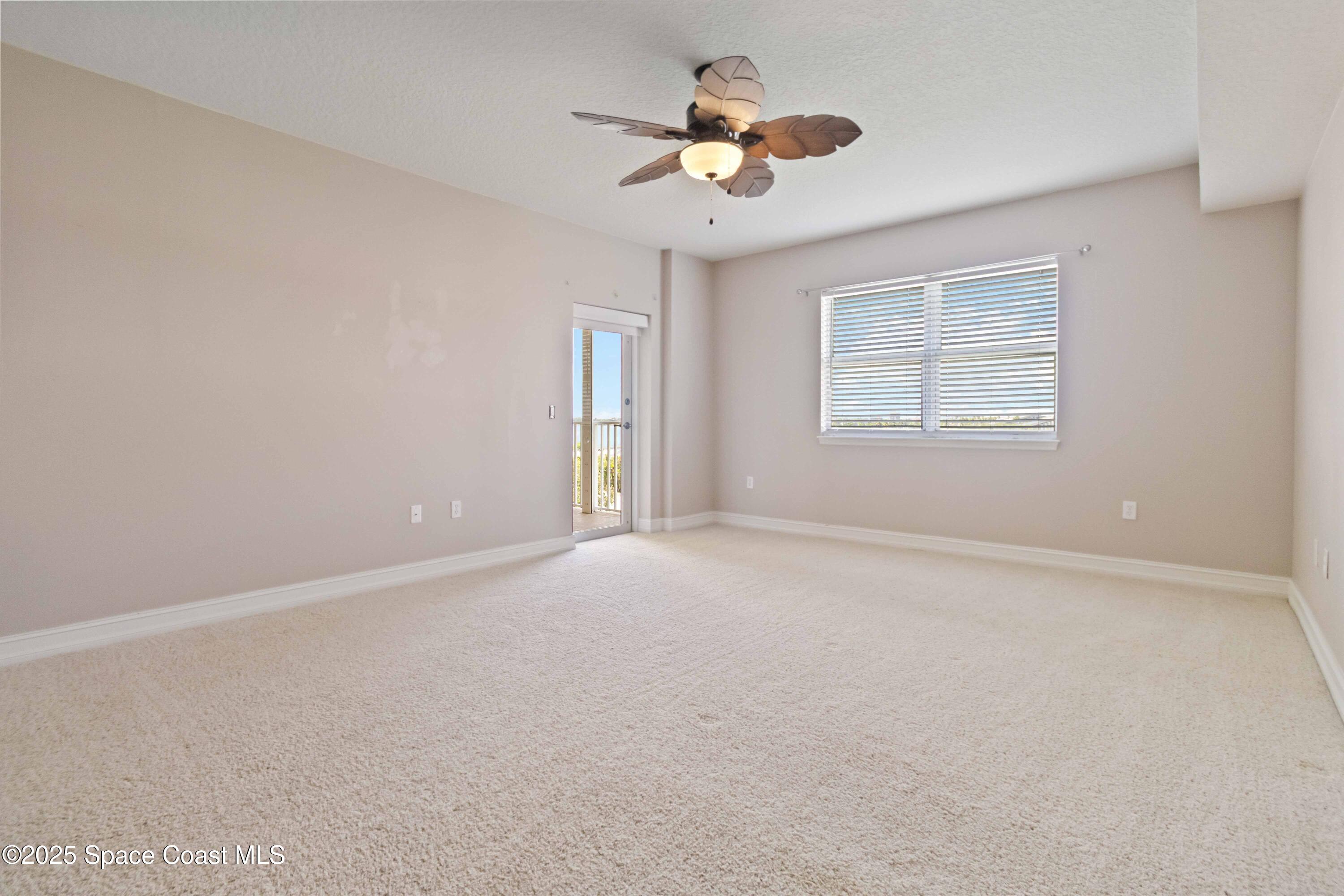 134 Starboard Lane, Unit 404 Merritt Island, FL 32953 - Photo 14 of 30 an empty room with a window and a fan