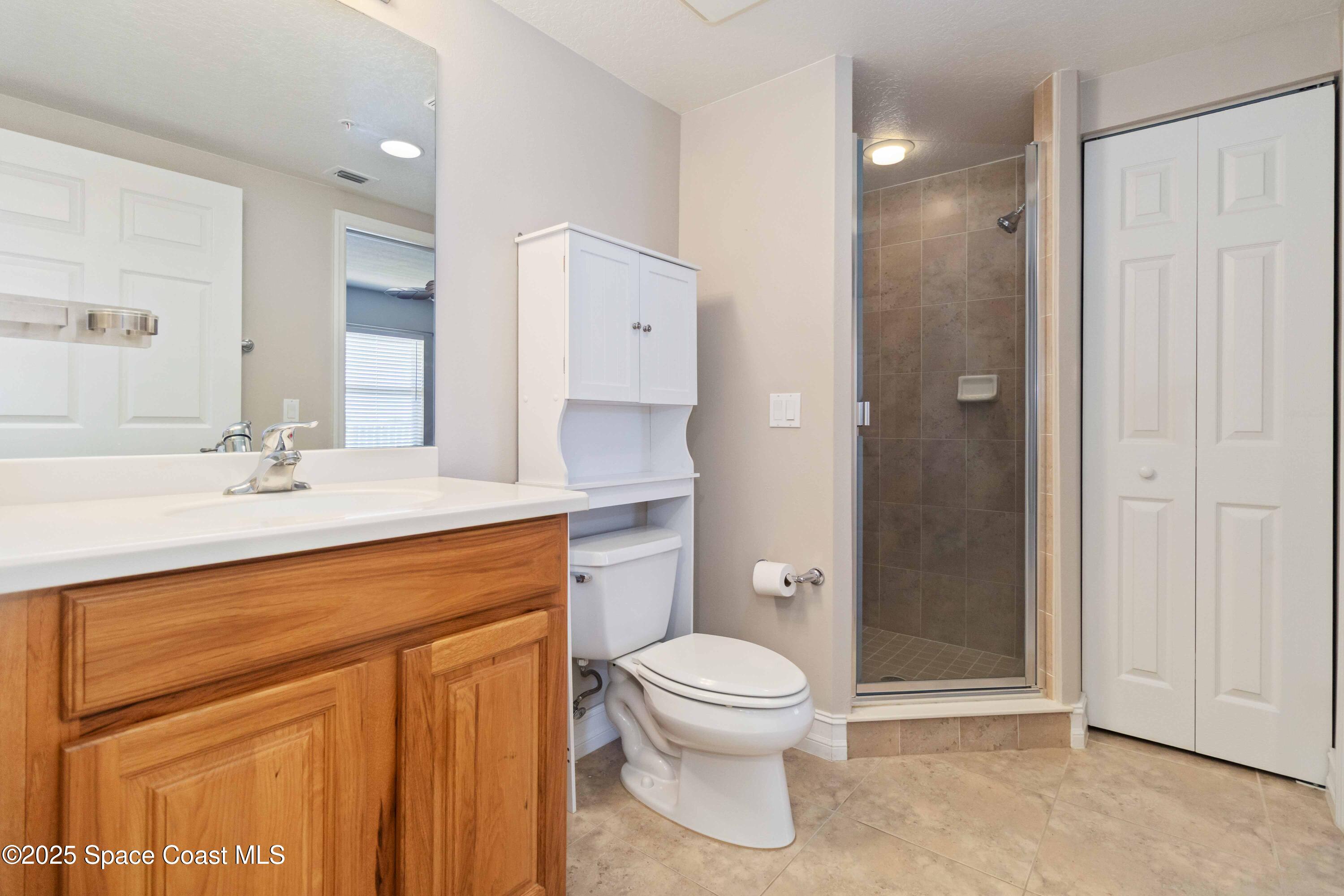 134 Starboard Lane, Unit 404 Merritt Island, FL 32953 - Photo 17 of 30 a spacious bathroom with a sink a toilet and shower